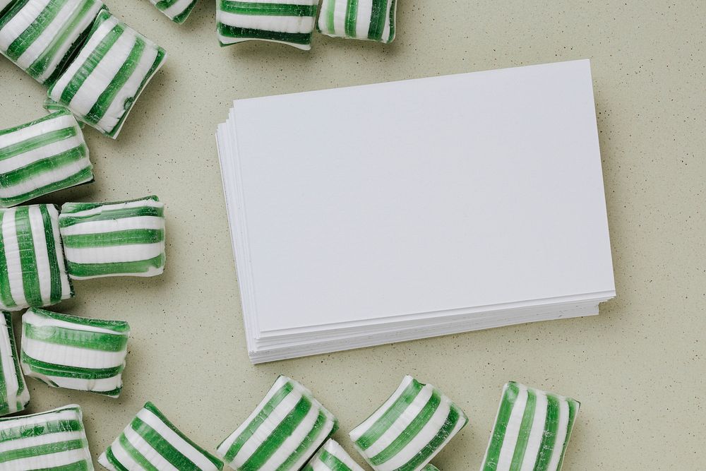 Business card mockup surrounded by candies 