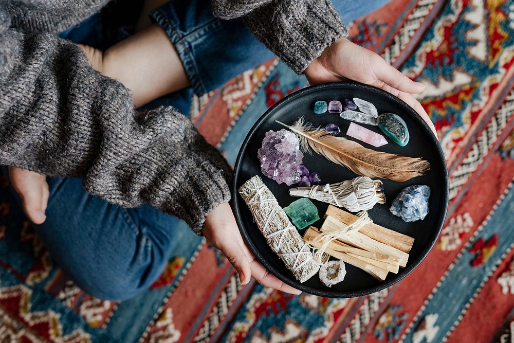 Woman with sage and crystals ready for smudging
