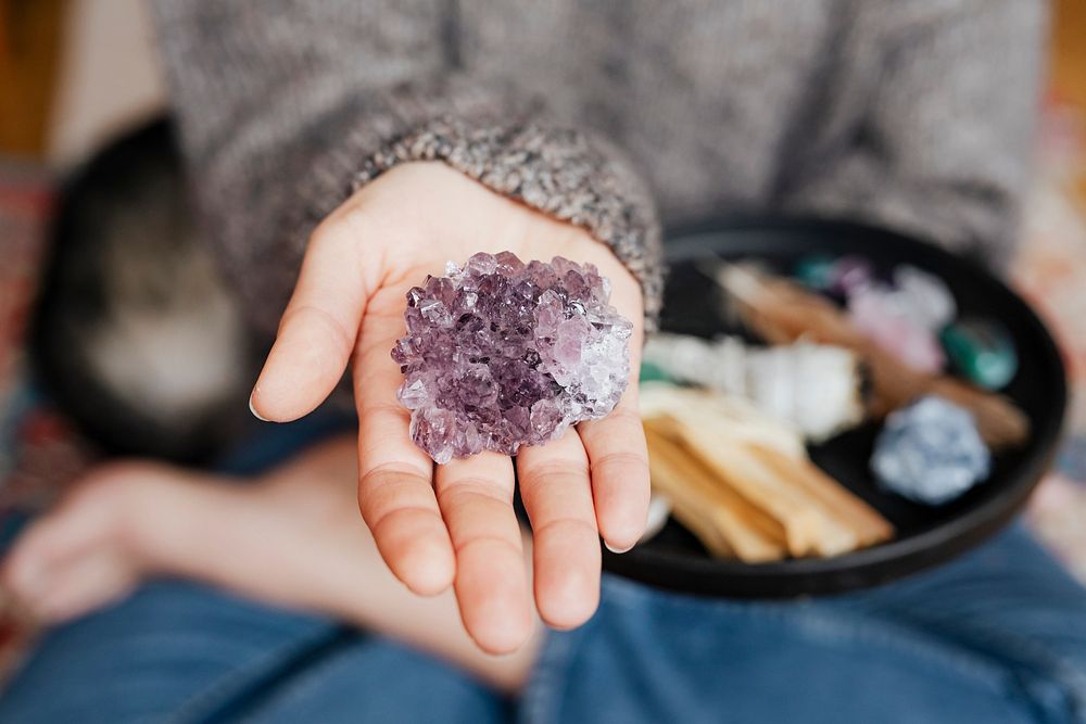 Woman with amethyst healing crystal 