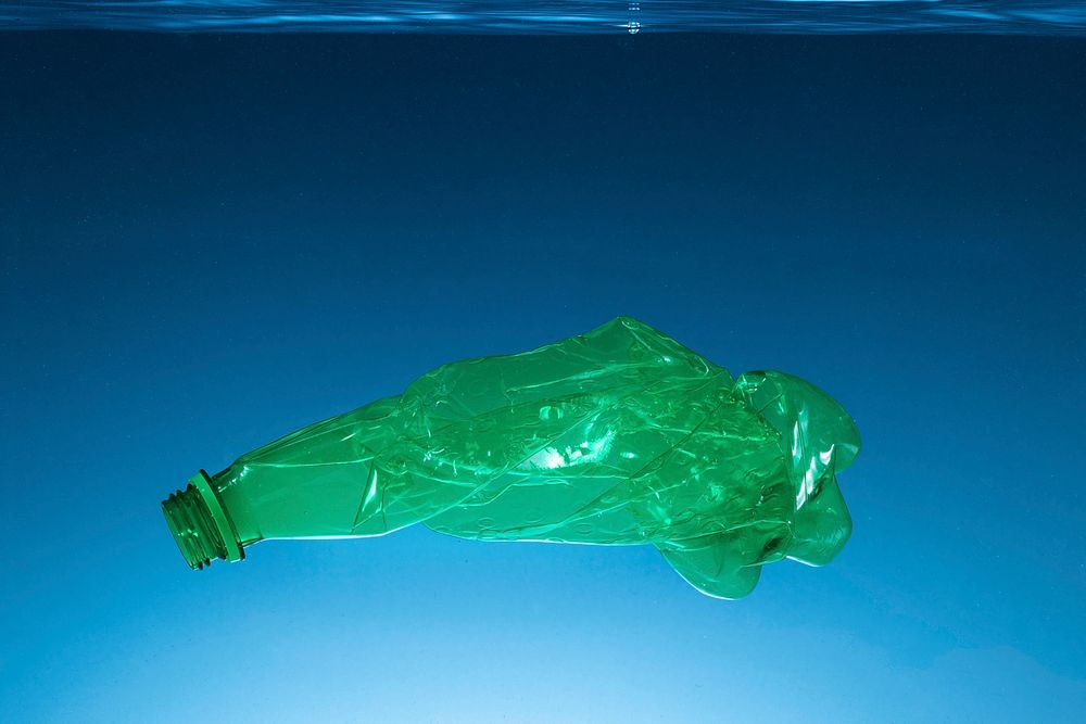 Crumpled plastic bottle polluting the ocean