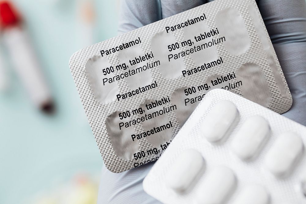 Hand holding paracetamol medicine packets