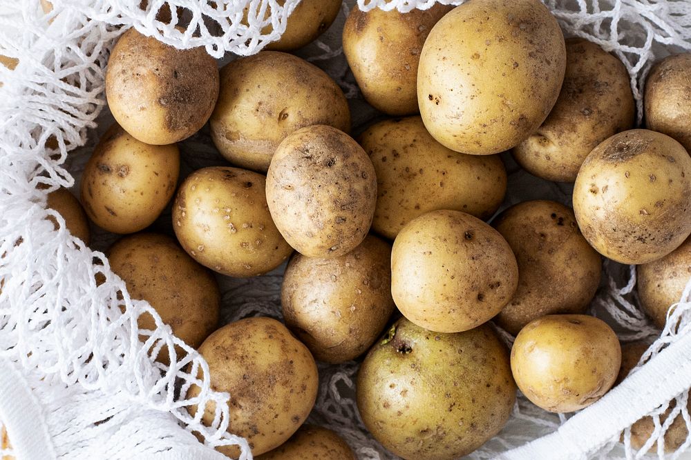 Fresh natural raw potatoes in white bag