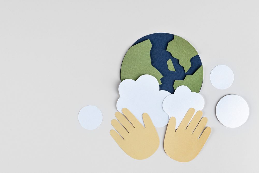 Hands washing the planet earth paper craft background