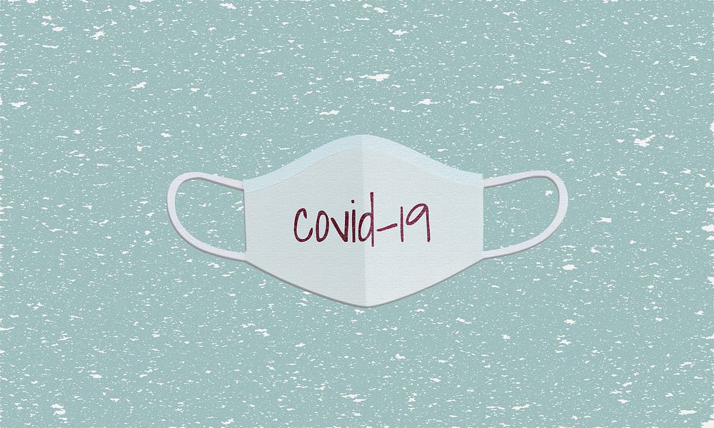 COVID-19 paper craft surgical face mask on a green textured background