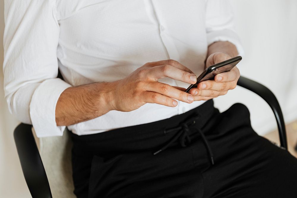 Businessman checking his social media account and messages on a phone