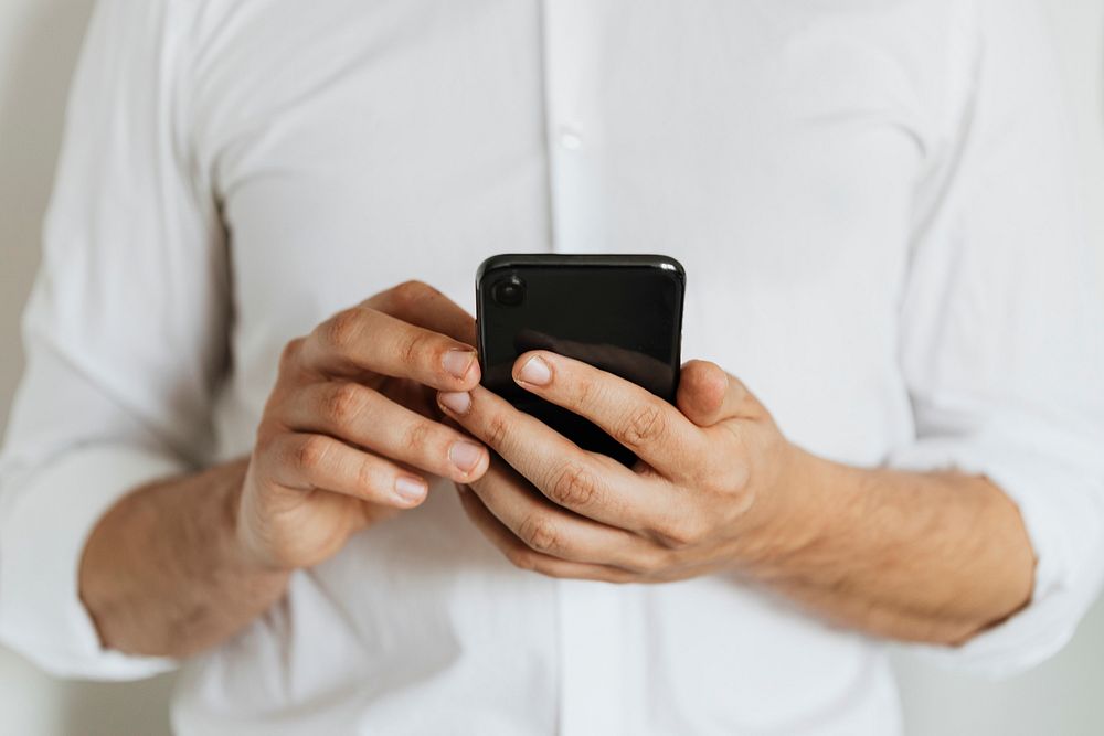 Businessman checking his social media account and messages on a phone