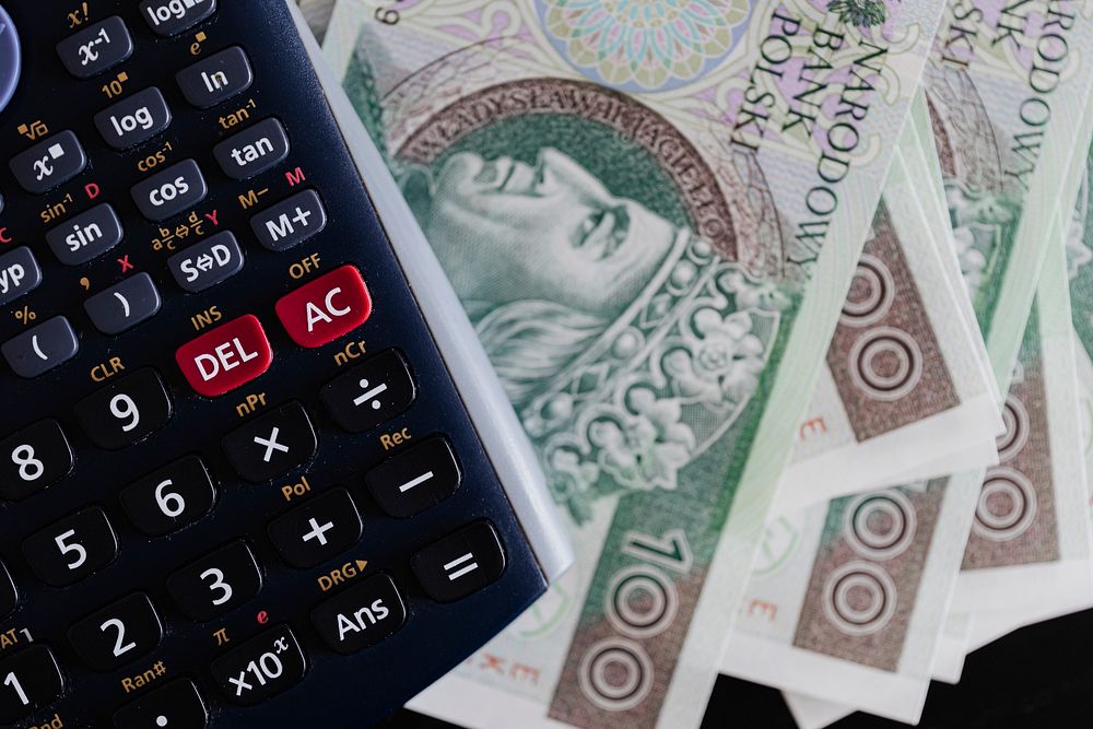 Calculator and Polish Zloty currency banknotes on a table
