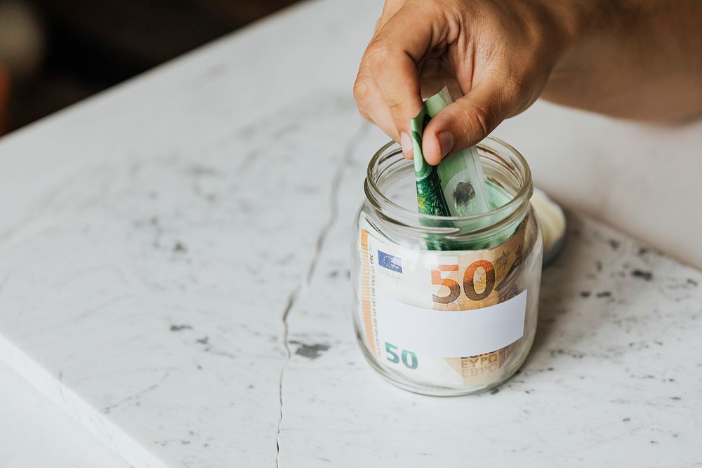 Saving money in a jar during the COVID-19 pandemic
