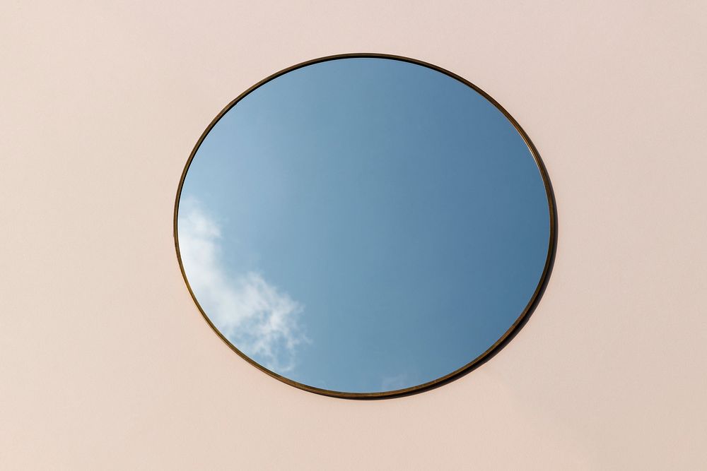 Blue sky reflection on a round mirror