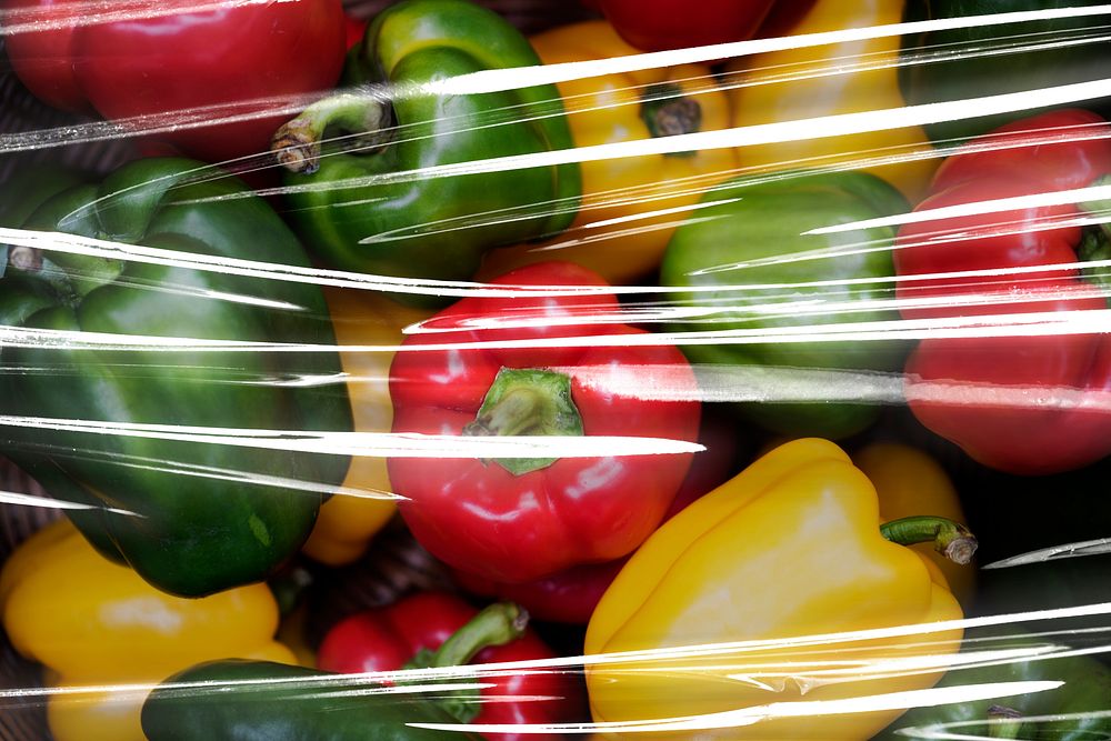 Fresh bell peppers covered with plastic wrap textured background wallpaper