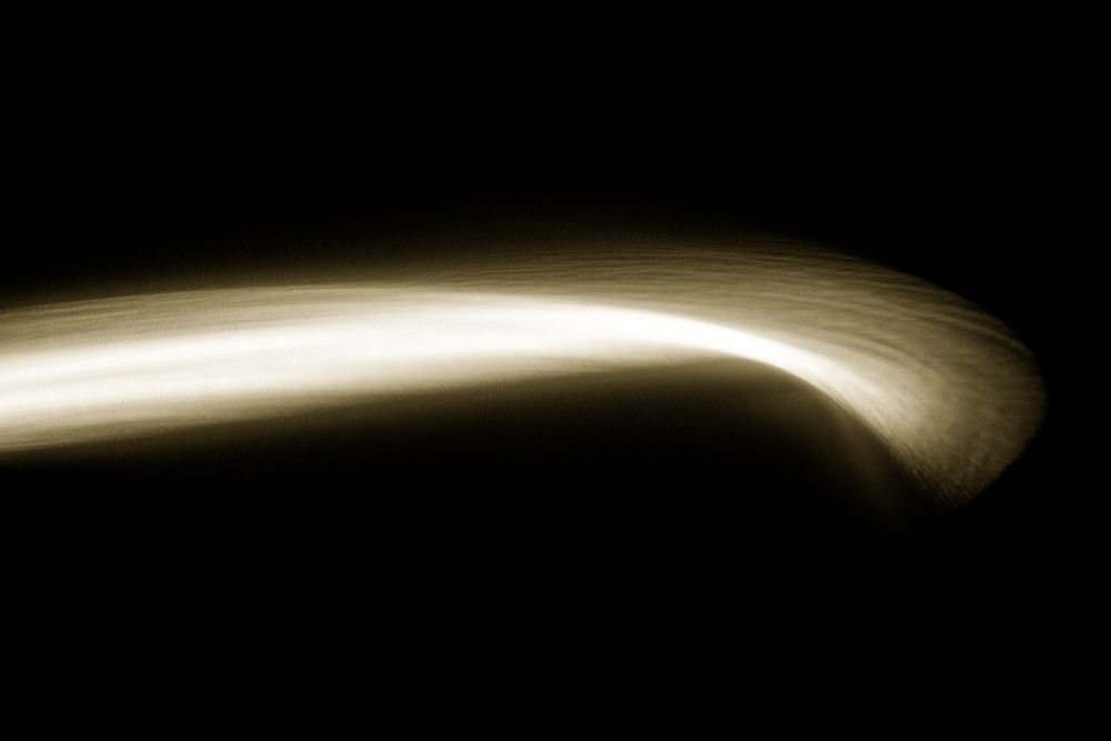 Gold long exposure light effect on a dark background wallpaper