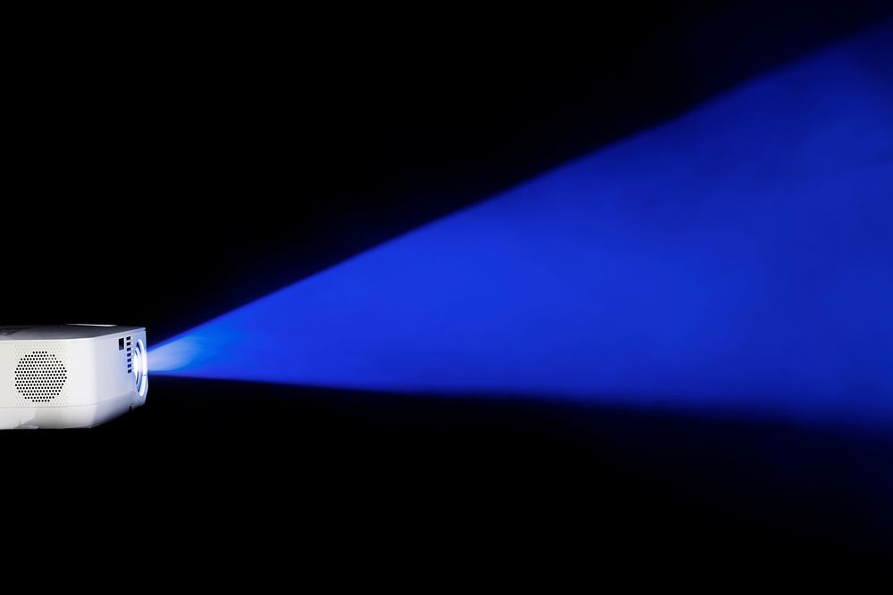 Blue projector light in the dark background wallpaper