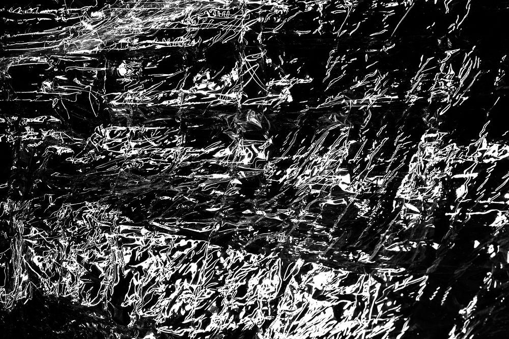 Wrinkled plastic wrap texture on a black background wallpaper