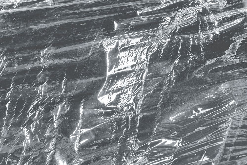 Wrinkled plastic wrap texture design element on a black background