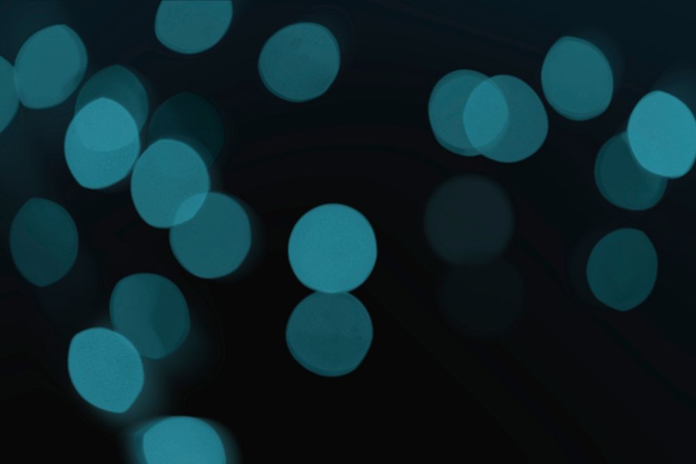 Teal bokeh pattern design element on a dark background