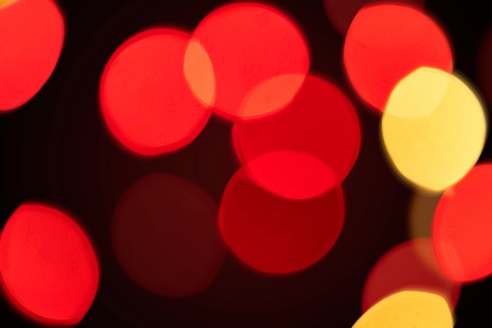 Red and yellow bokeh pattern design element on a dark background