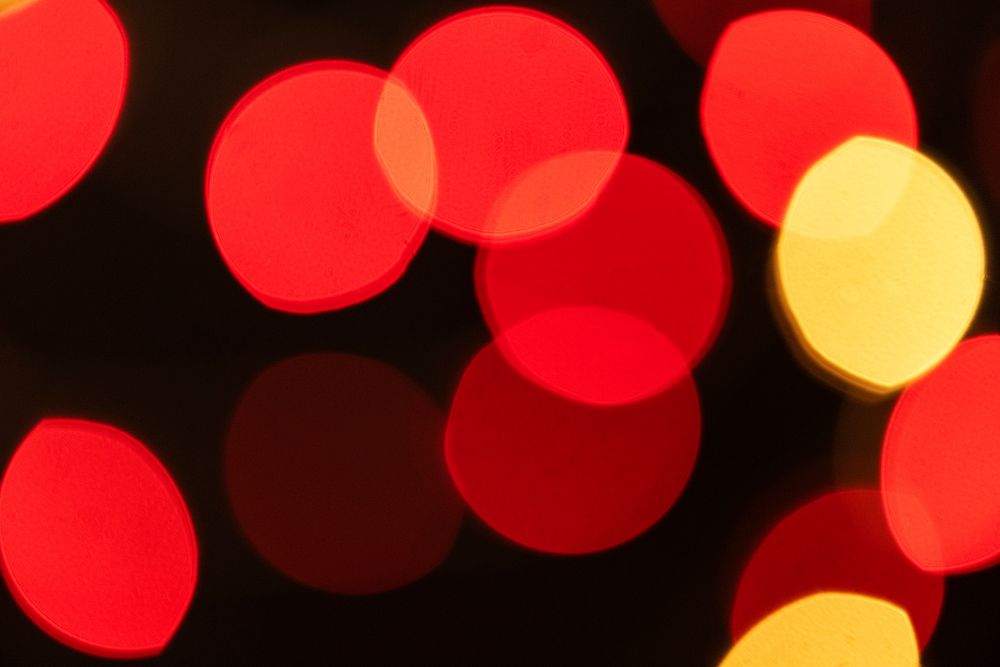 Red and yellow bokeh pattern on a dark background wallpaper