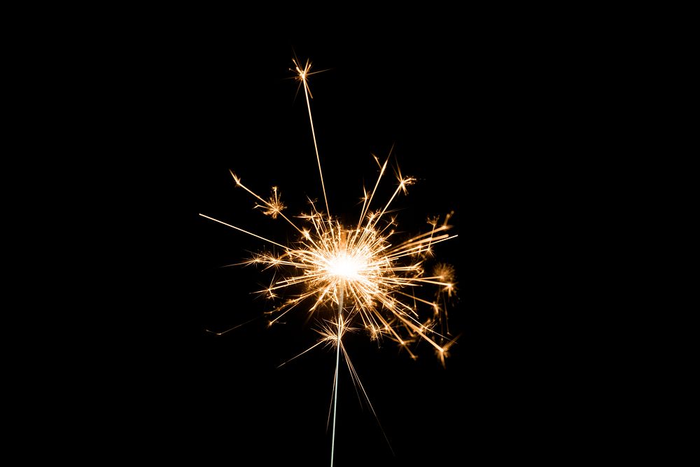 Burning sparkler on a black background wallpaper