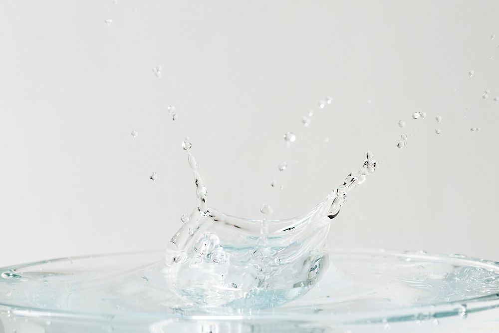 Water splash on top of the glass background wallpaper