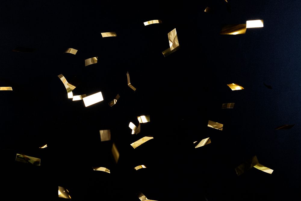 Gold confetti pattern on a black background wallpaper