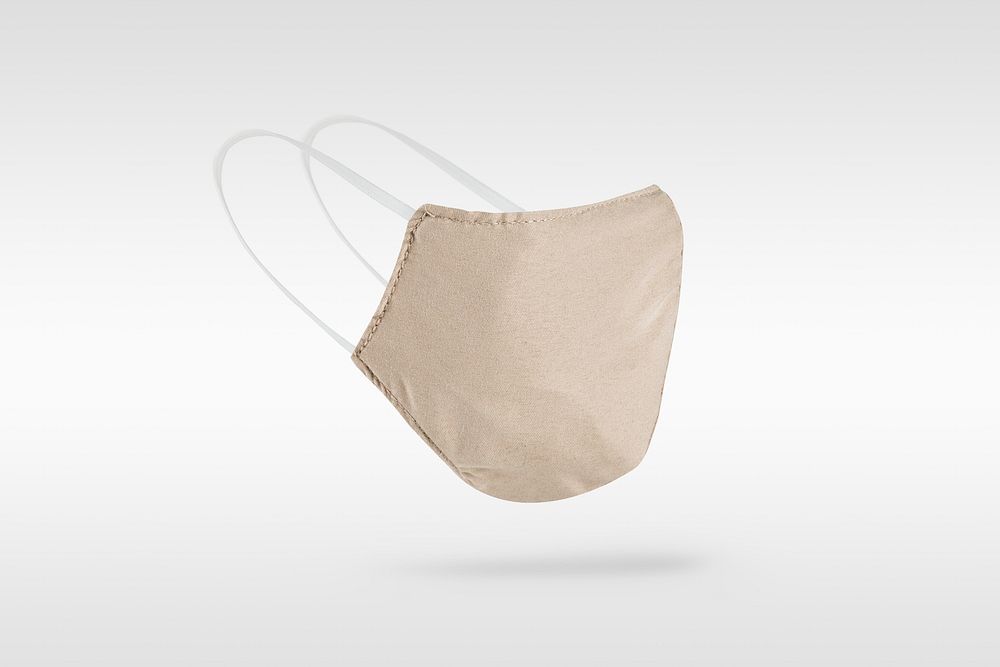 Beige fabric face mask on a gray  background