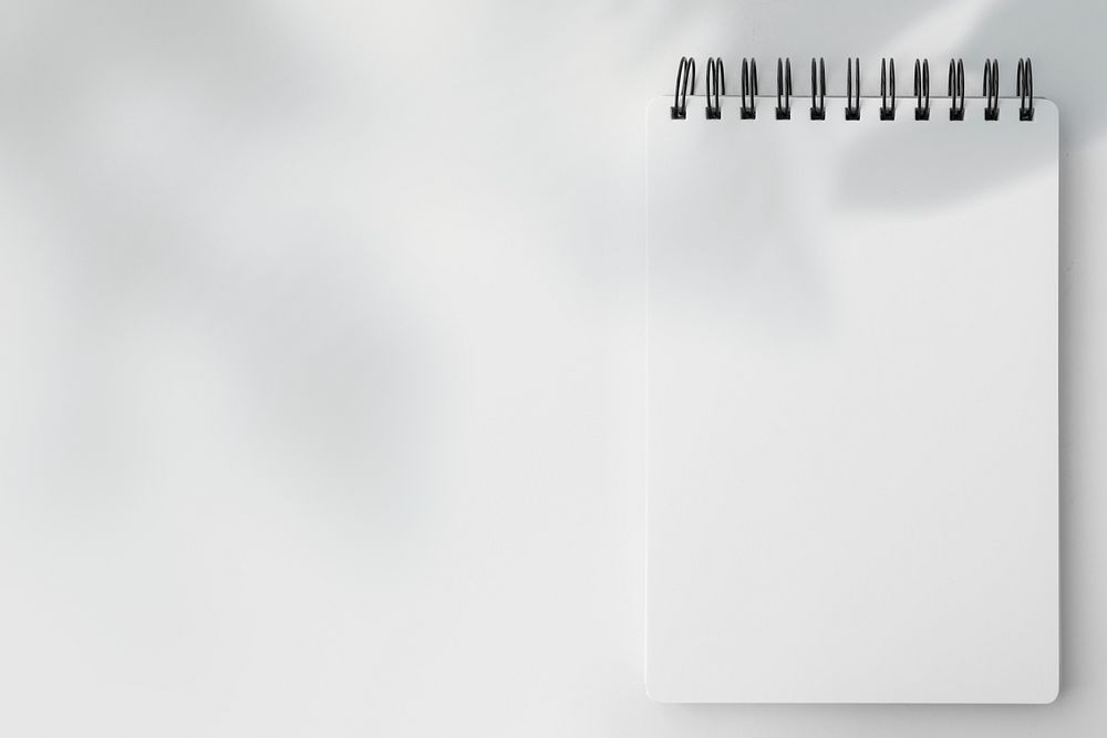 Blank white ruled notebook on a white table