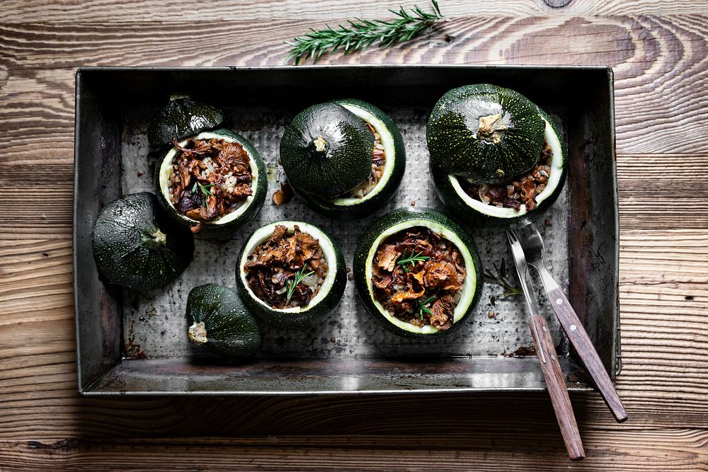 Homemade chanterelle stuffed round zucchini on wooden table