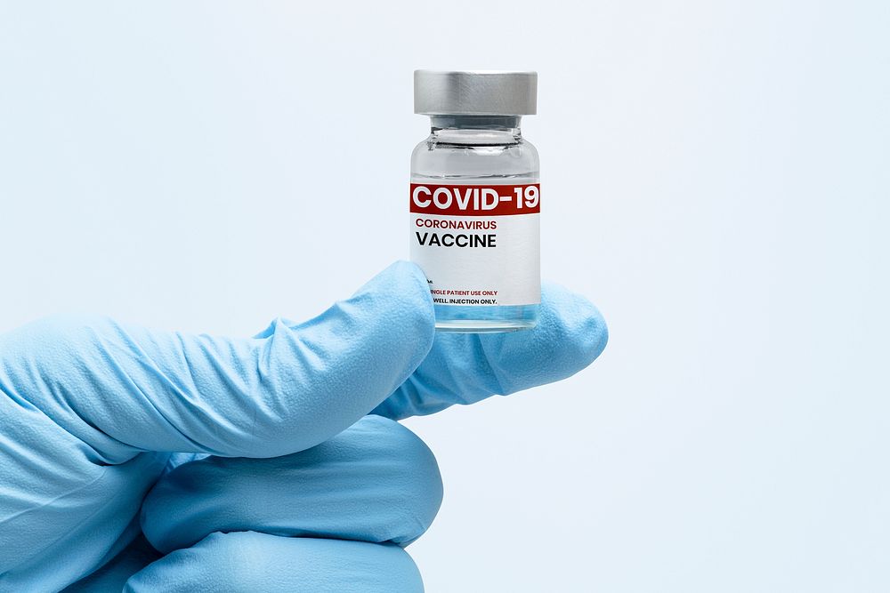 COVID-19 vaccine bottle in scientist's hand