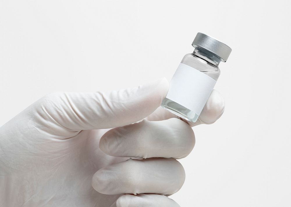 Medicine vial with label mockup psd in scientist's hand