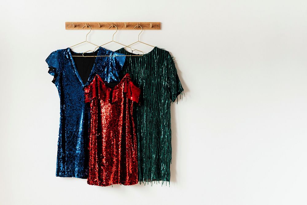 Shiny party dresses on a wall hanger