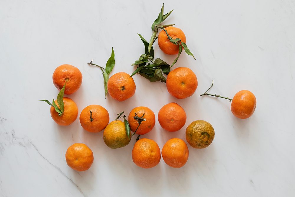 Bright clementines on a marble countertop