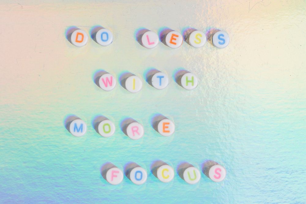 Colorful DO LESS WITH MORE FOCUS beads typography