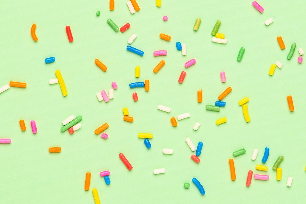 Colorful sprinkles pattern green wallpaper background