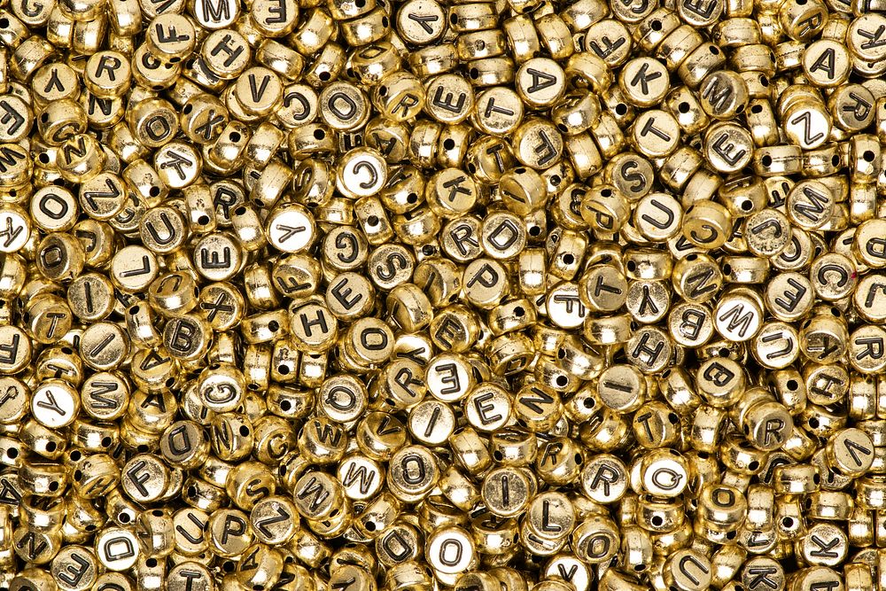 Metallic gold English alphabet beads background