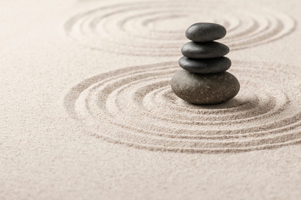 Stacked zen stones sand background art of balance concept