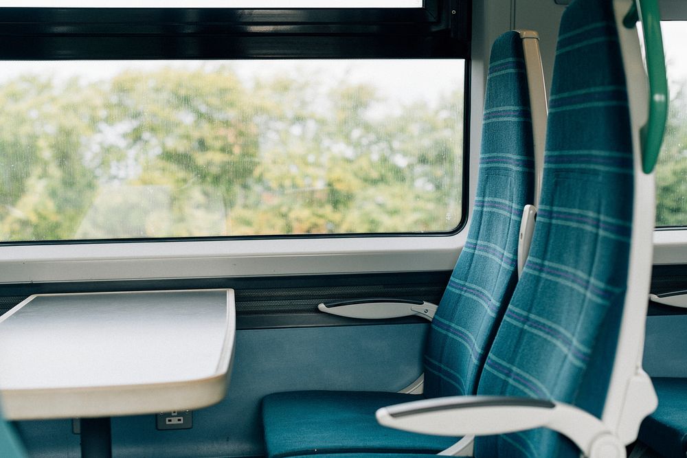 Empty seats with a tray on a train