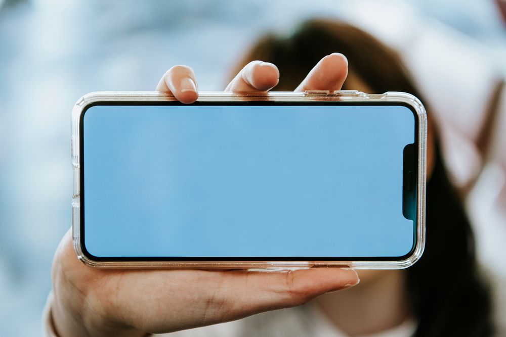 Woman holding a mobile phone screen mockup