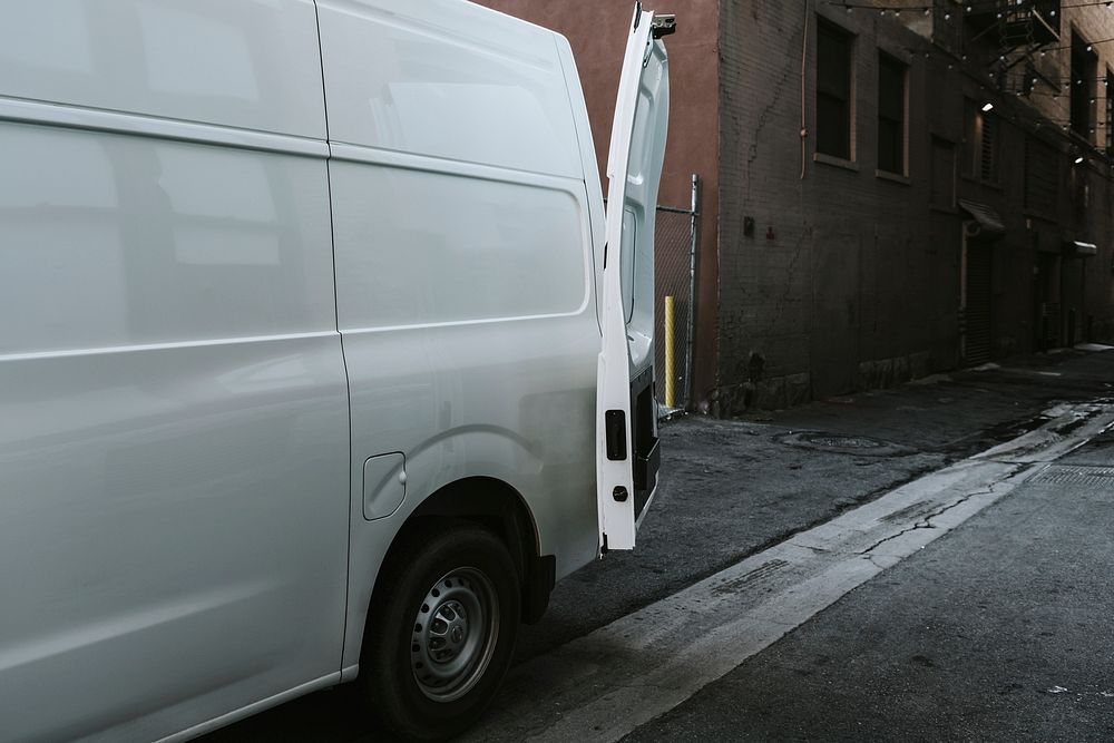 White delivery truck parking in an alley