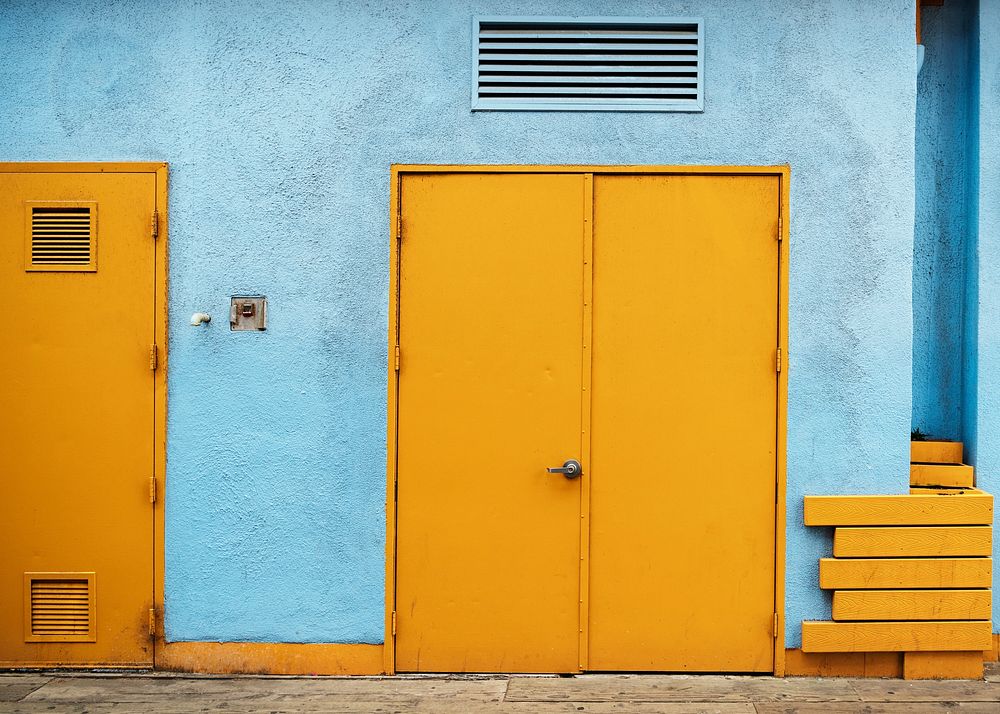 Yellow doors with a pale blue wall