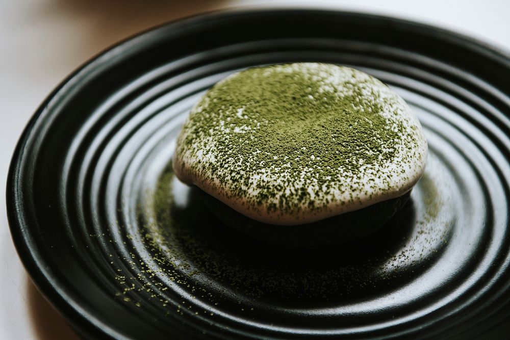 Green tea donut on a black plate