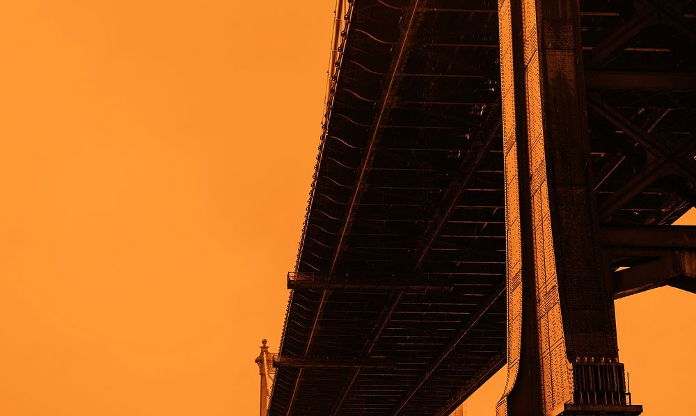 Suspension bridge with an orange background