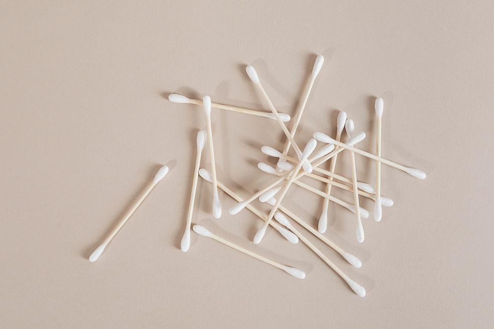 Natural cotton buds isolated on beige background