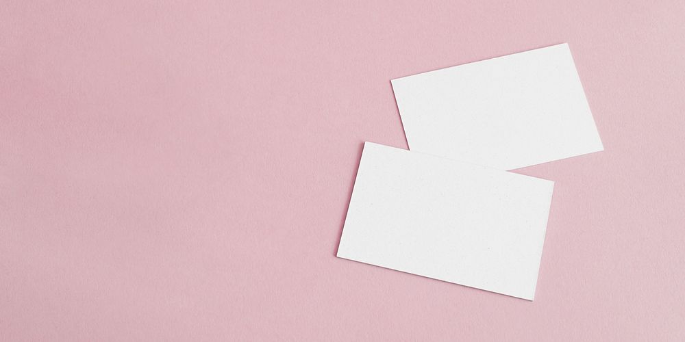 Blank white business cards on pink social banner