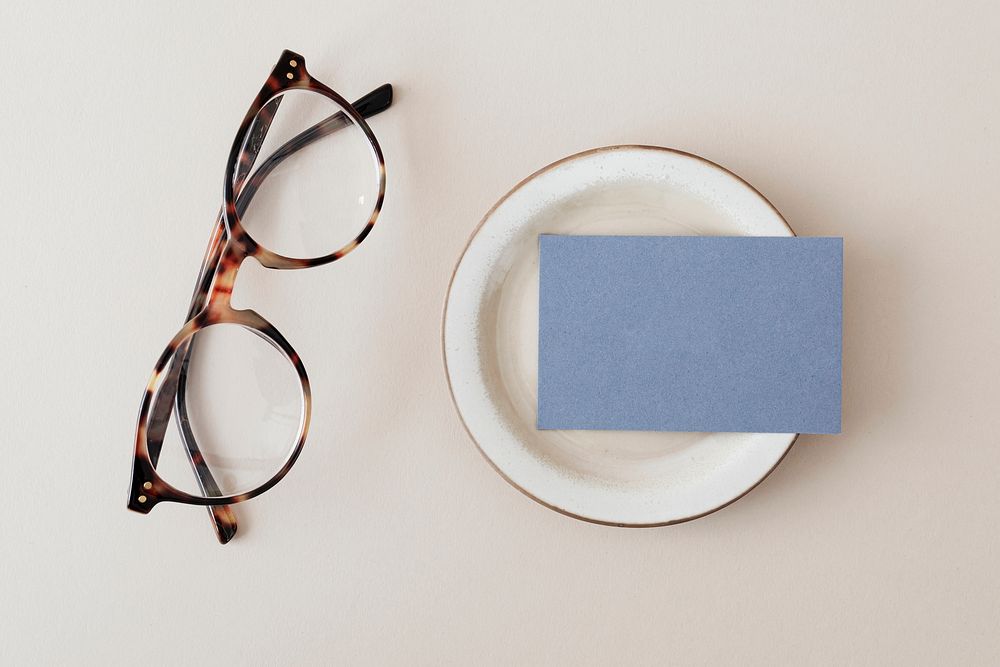 Blue business card on a plate with glasses mockup