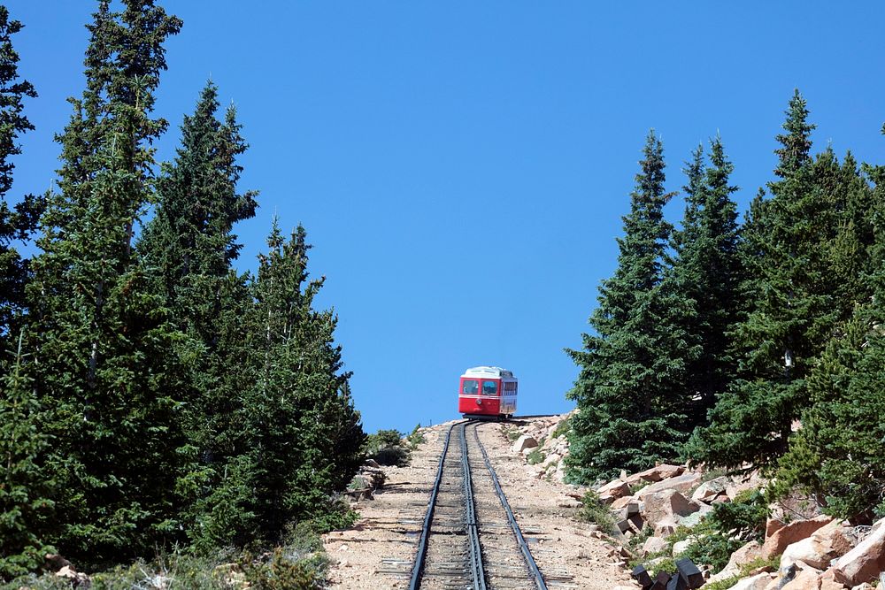 Both coming and going are steep for the Pikes Peak Cog Railway, which ascends Colorado's famous 14,115-foot Pikes Peak from…