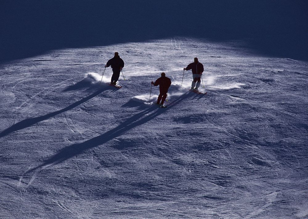 Alpine Skier Skiing Downhill, Blue Sky On Background