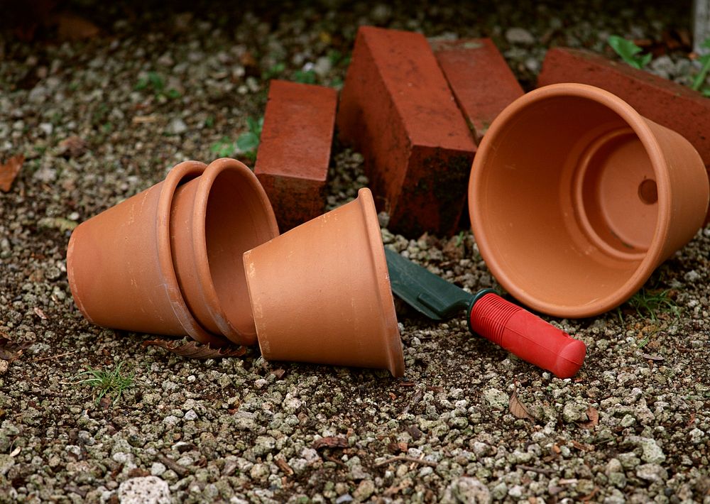 Different Sizes Of Terracotta Pots With Gardening Tool