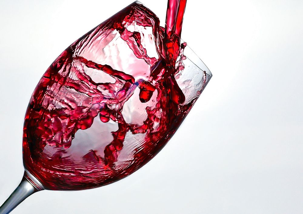 Pouring red wine in glass image, free public domain drink CC0 photo.