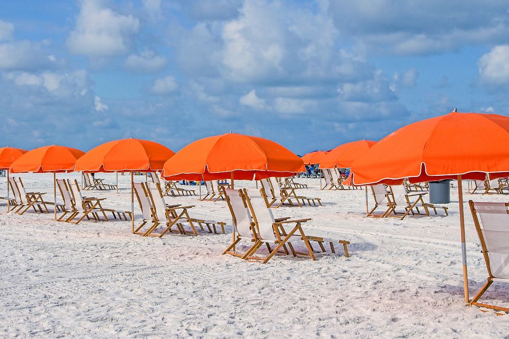 Red umbrealla, shades on sandy beach photo, free public domain CC0 image.