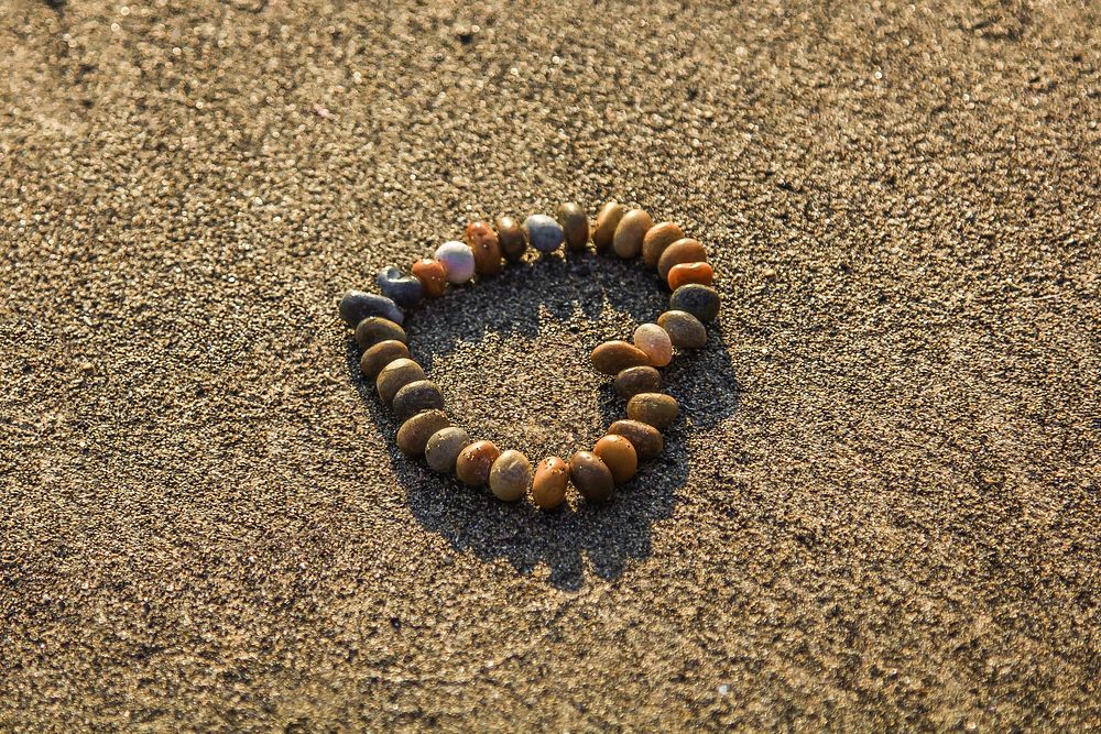 Free heart shaped stones on the beach image, public domain CC0 photo.